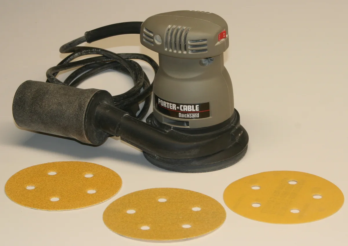 Category example: a corded random orbital sander on a white background.
